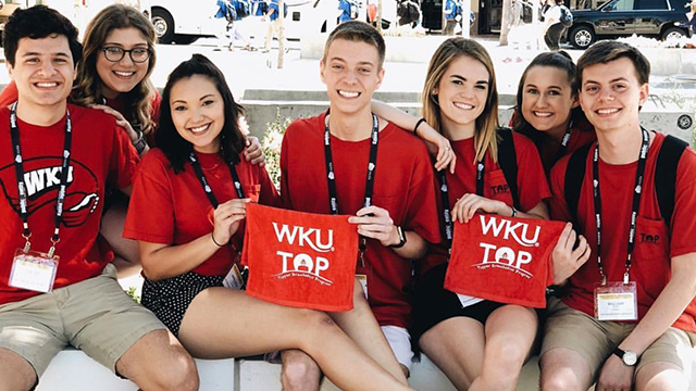 Students attending the Topper Orientation Program holding WKU red towels